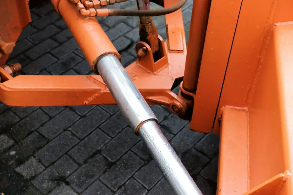 Hydraulic cylinder attached to orange machinery, illustrating comparing winch-system requirements